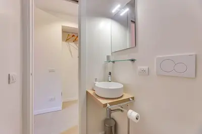 a white bathroom with a sink and a mirror at New home trastevere in Rome
