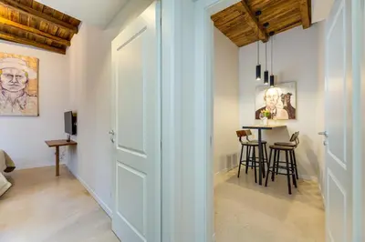 a hallway with a door leading to a dining room with a table at New home trastevere in Rome