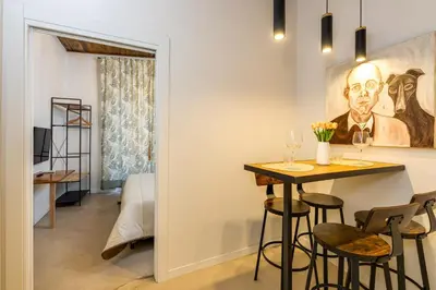 a room with a table and chairs and a bedroom at New home trastevere in Rome