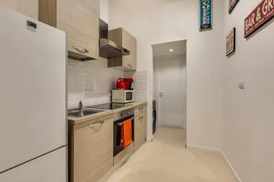 a small kitchen with a sink and a refrigerator at New home trastevere in Rome