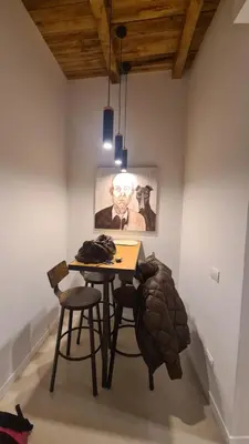 a table and two chairs in a room with a painting at New home trastevere in Rome