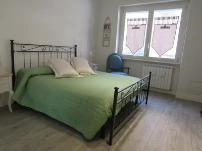 a bedroom with a bed with a green comforter at Casa Francesca in Rome