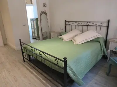 a bedroom with a bed with green sheets and pillows at Casa Francesca in Rome