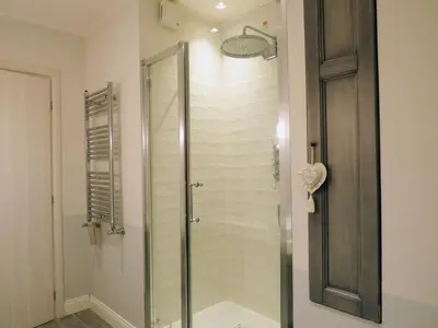 a shower with a glass door in a bathroom at Casa Francesca in Rome