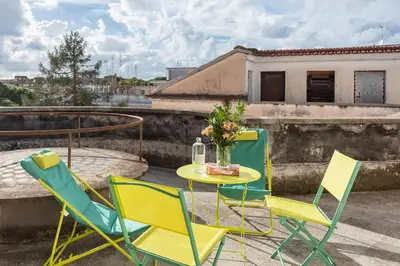 a table and chairs sitting on a roof at Menta luxury apartment Rome in Rome