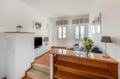 a living room with a table and a tv at Menta luxury apartment Rome in Rome
