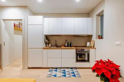 a kitchen with white cabinets and a stove at Welcome to Retreat in Trastevere in Rome