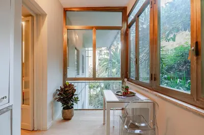 a room with a table and a large window at Welcome to Retreat in Trastevere in Rome