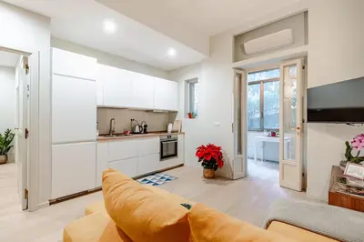 a living room with a couch and a kitchen at Welcome to Retreat in Trastevere in Rome