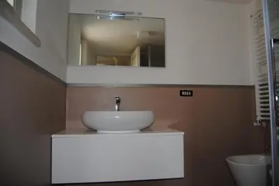 a bathroom with a white sink and a mirror at Trullo Amato with exclusive pool in Rome