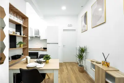 a kitchen and dining room with a table and chairs at Centocinque Aparthouse - Luxe in Rome