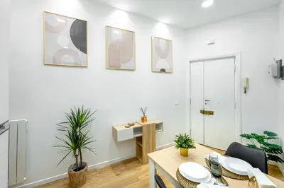 a living room with a table and a desk at Centocinque Aparthouse - Luxe in Rome