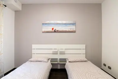 a bedroom with two beds and a painting on the wall at Butterfly House Ponte Milvio in Rome