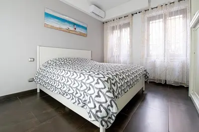 a bedroom with a bed with a black and white comforter at Butterfly House Ponte Milvio in Rome