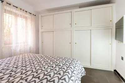 a bedroom with white cabinets and a bed at Butterfly House Ponte Milvio in Rome