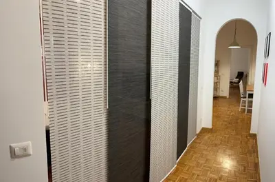 a hallway with black and white walls in a room at Rhome311 - Vatican Apartment in Rome