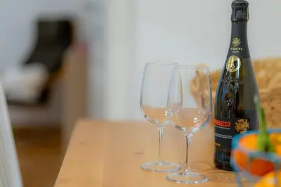 two wine glasses sitting next to a bottle of champagne at Rhome311 - Vatican Apartment in Rome