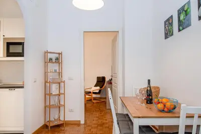 a kitchen and a dining room with a table at Rhome311 - Vatican Apartment in Rome