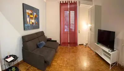 a living room with a couch and a flat screen tv at Rhome311 - Vatican Apartment in Rome