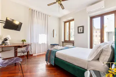 a hallway with a wooden door and a kitchen at Calm Home - Center Rome in Rome