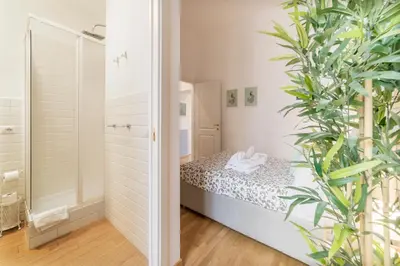 a small bedroom with a bed and a plant at CS Central Station Termini Monti Apartment in Rome