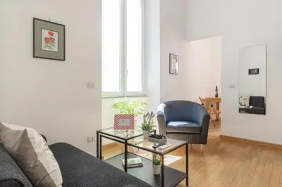 a living room with a couch and a chair at CS Central Station Termini Monti Apartment in Rome