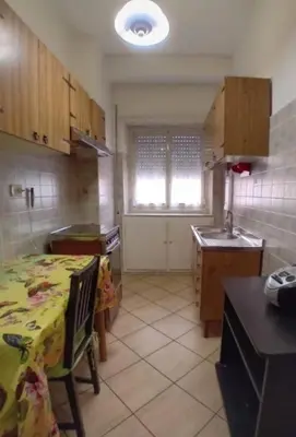 a kitchen with a table with a yellow table cloth on it at Intero appartamento Marconi in Rome