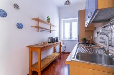 a kitchen with a sink and a wooden counter at iFlat Vatican Comfortable & Peaceful Retreat in Rome