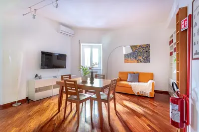 a living room with a table and a couch at iFlat Vatican Comfortable & Peaceful Retreat in Rome