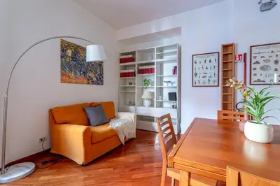 a living room with a table and a couch at iFlat Vatican Comfortable & Peaceful Retreat in Rome