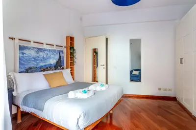 a bedroom with a bed with two dolls on it at iFlat Vatican Comfortable & Peaceful Retreat in Rome