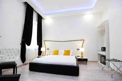 a bedroom with a large bed with yellow pillows at Escape Suite Guest House - Ca Domus Collection in Rome