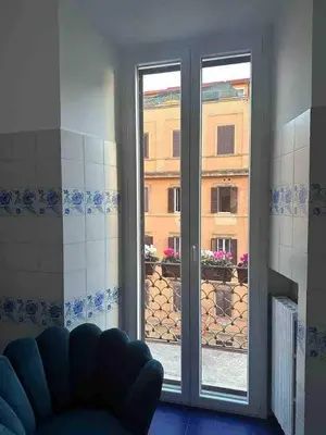 a room with a window with a view of a building at Luxury house Empire 96 in Rome