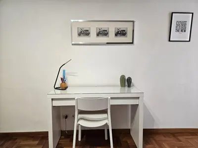 a white desk with a chair in a room at Be Your Home - Spritz Apartment in Rome