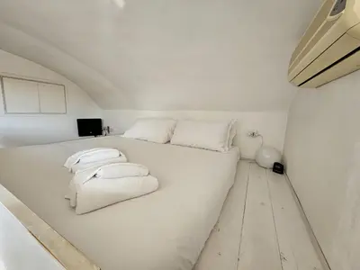 a white bed with towels on it in a room at Be Your Home - Spritz Apartment in Rome