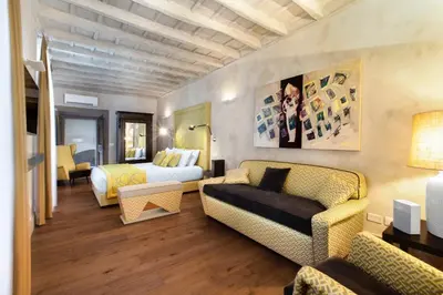 a hotel room with a bed and a couch and a bedroom at èROMA - PANTHEON LUXURY SUITE in Rome