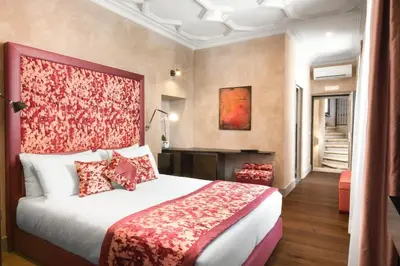 a hotel room with a bed and a staircase at èROMA - PANTHEON LUXURY SUITE in Rome