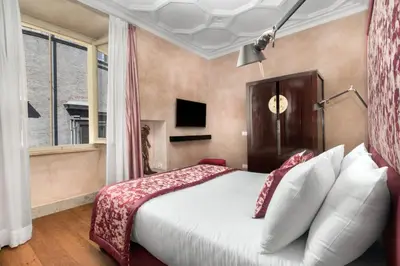 a bedroom with a large bed and a window at èROMA - PANTHEON LUXURY SUITE in Rome
