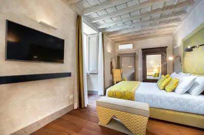a hotel room with a bed and a tv at èROMA - PANTHEON LUXURY SUITE in Rome