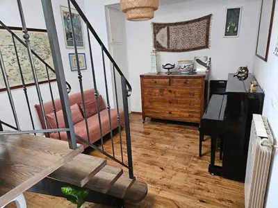 a living room with a couch and a wooden floor at Luminoso attico con terrazza in Rome