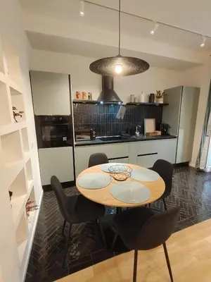 a kitchen with a table and chairs in a room at Bellissimo bilocale al centro di Roma - Daniele Case Vacanza in Rome