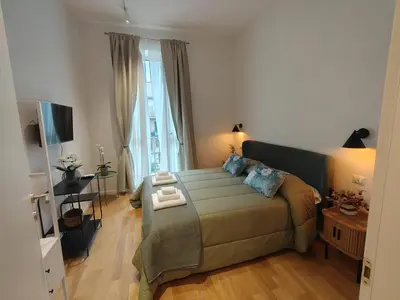 a living room with a bed and a large window at Bellissimo bilocale al centro di Roma - Daniele Case Vacanza in Rome