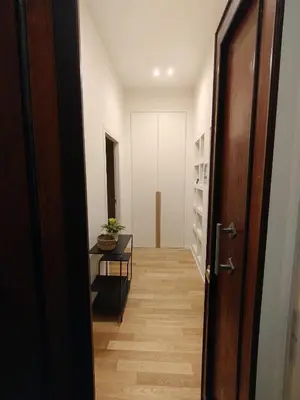 a hallway with a wooden floor and a door at Bellissimo bilocale al centro di Roma - Daniele Case Vacanza in Rome