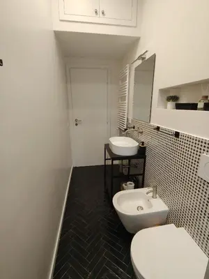 a bathroom with a white toilet and a sink at Bellissimo bilocale al centro di Roma - Daniele Case Vacanza in Rome