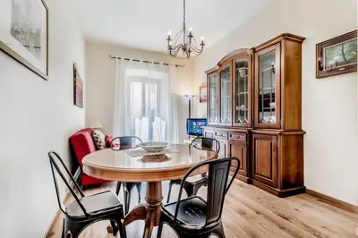 a dining room with a table and chairs at Elegant flat in front of Vatican museum in Rome