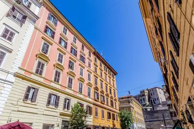a large building in the middle of two other buildings at Elegant flat in front of Vatican museum in Rome