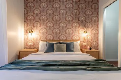 a bedroom with a bed with a red wall at Ambra - Liberty Apartment at the Imperial Forums in Rome