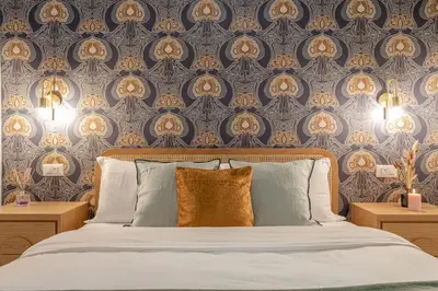 a bedroom with a bed with blue and gold wallpaper at Ambra - Liberty Apartment at the Imperial Forums in Rome