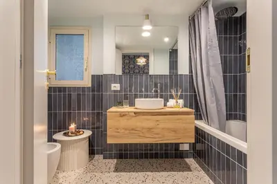 a bathroom with a sink and a toilet at Ambra - Liberty Apartment at the Imperial Forums in Rome