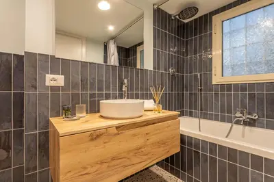 a bathroom with a sink and a tub at Ambra - Liberty Apartment at the Imperial Forums in Rome